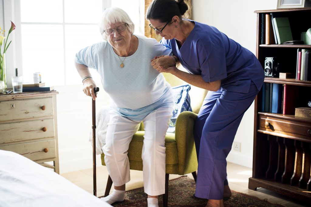 "Nurse helping senior woman to stand" home and community-based services